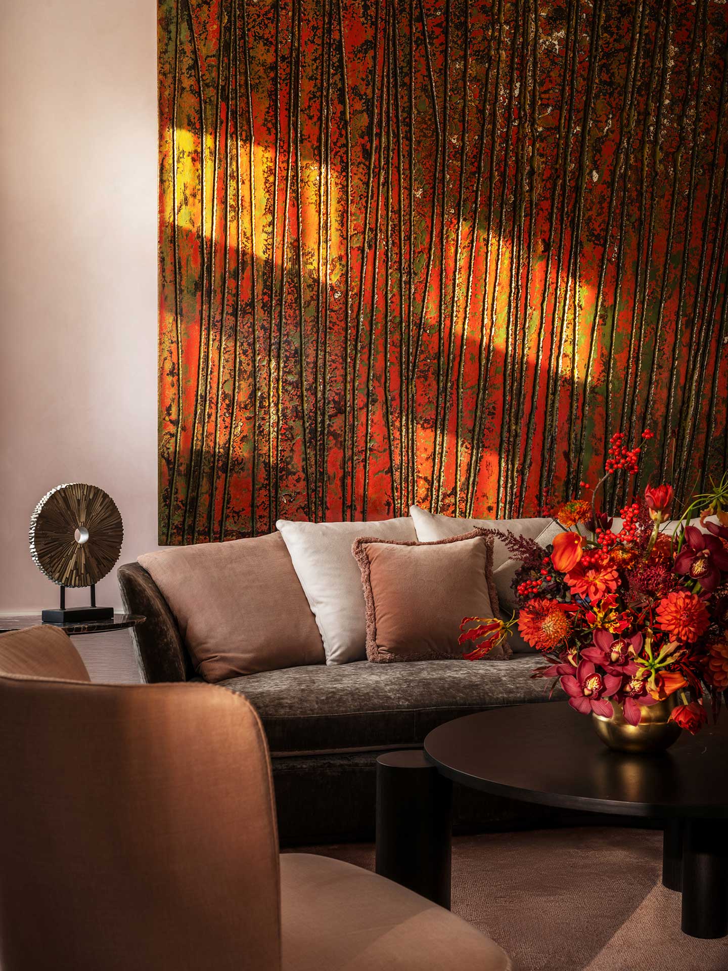 Harrods Residence Cha House Shanghai — close-up of the abstract red-and-gold feature artwork with soft neutral seating and a bold red floral centrepiece