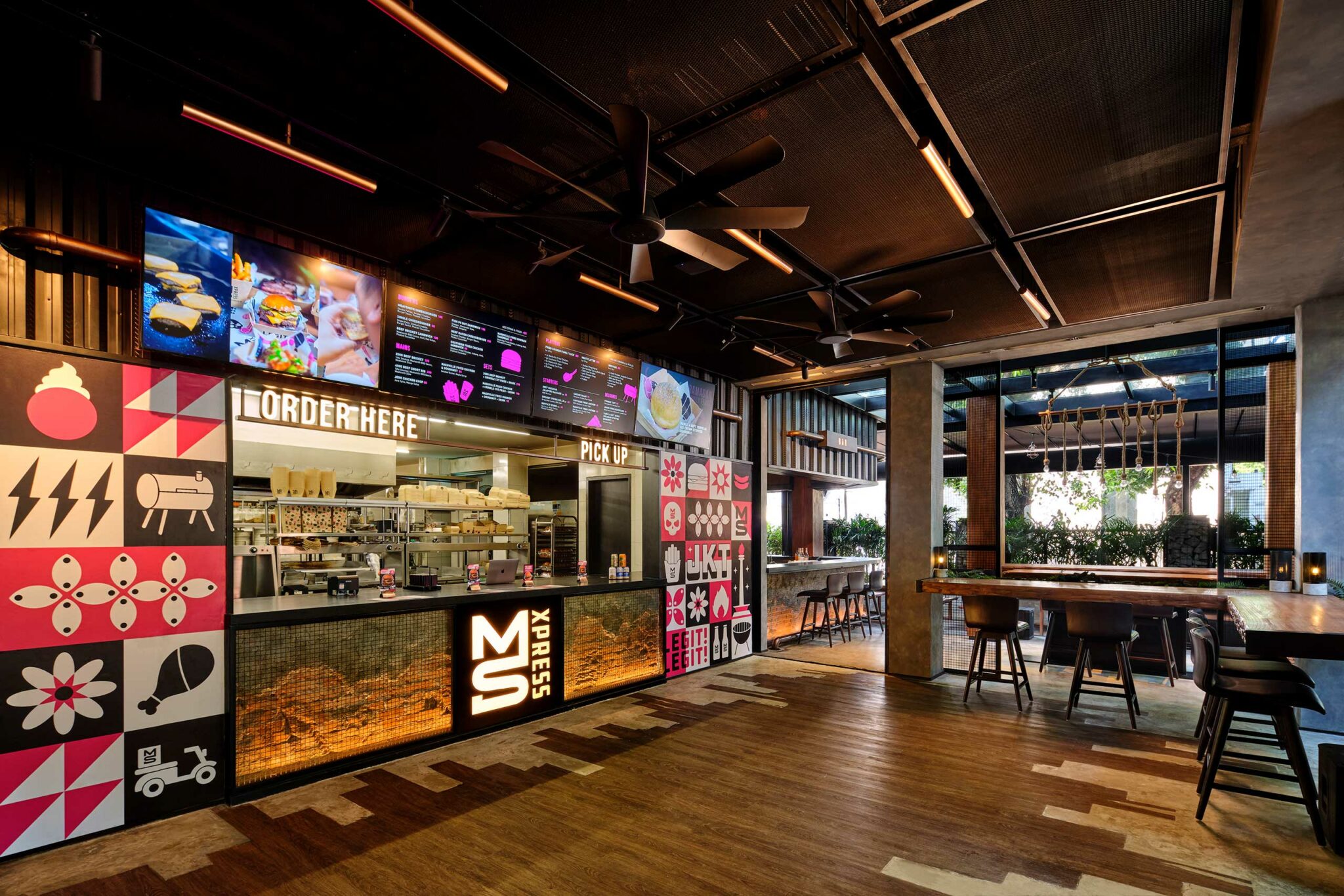 Fast-casual counter concept for MS XPRESS in Jakarta, featuring bold graphic branding, illuminated menu boards, and an open kitchen layout designed for high-volume, high-visibility service.