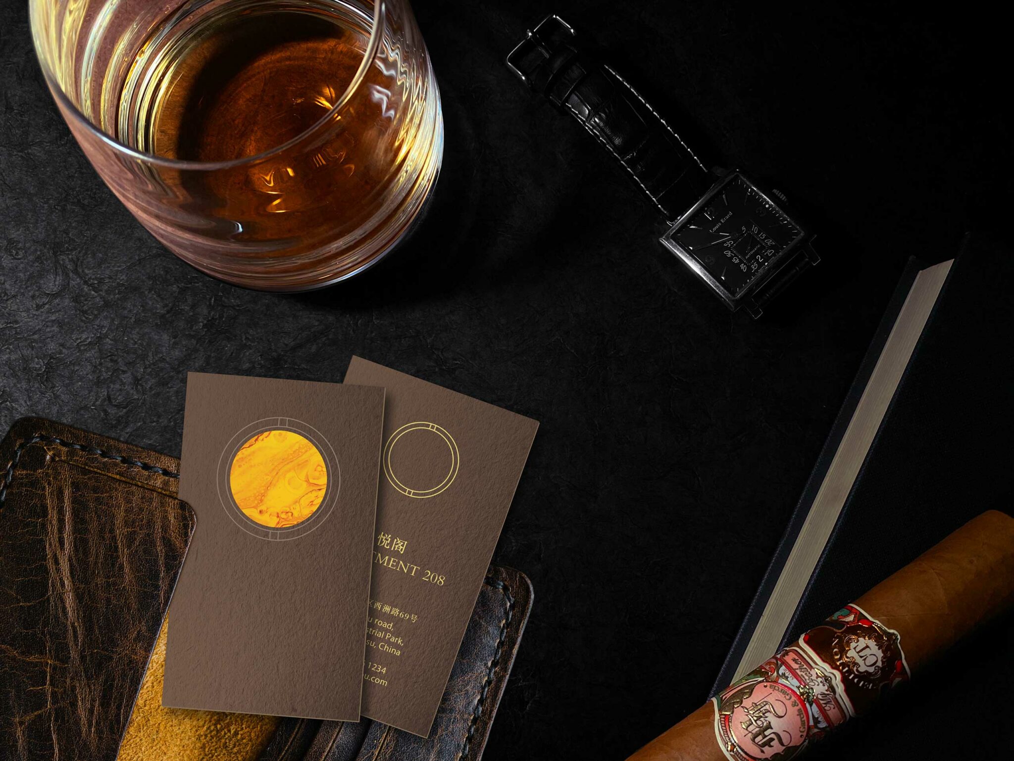 Close-up brand image for Apartment 208 at Park Hyatt Suzhou, showcasing whisky, cigar, textured leather, and elegant printed collateral inspired by tobacco hues and refined craftsmanship.
