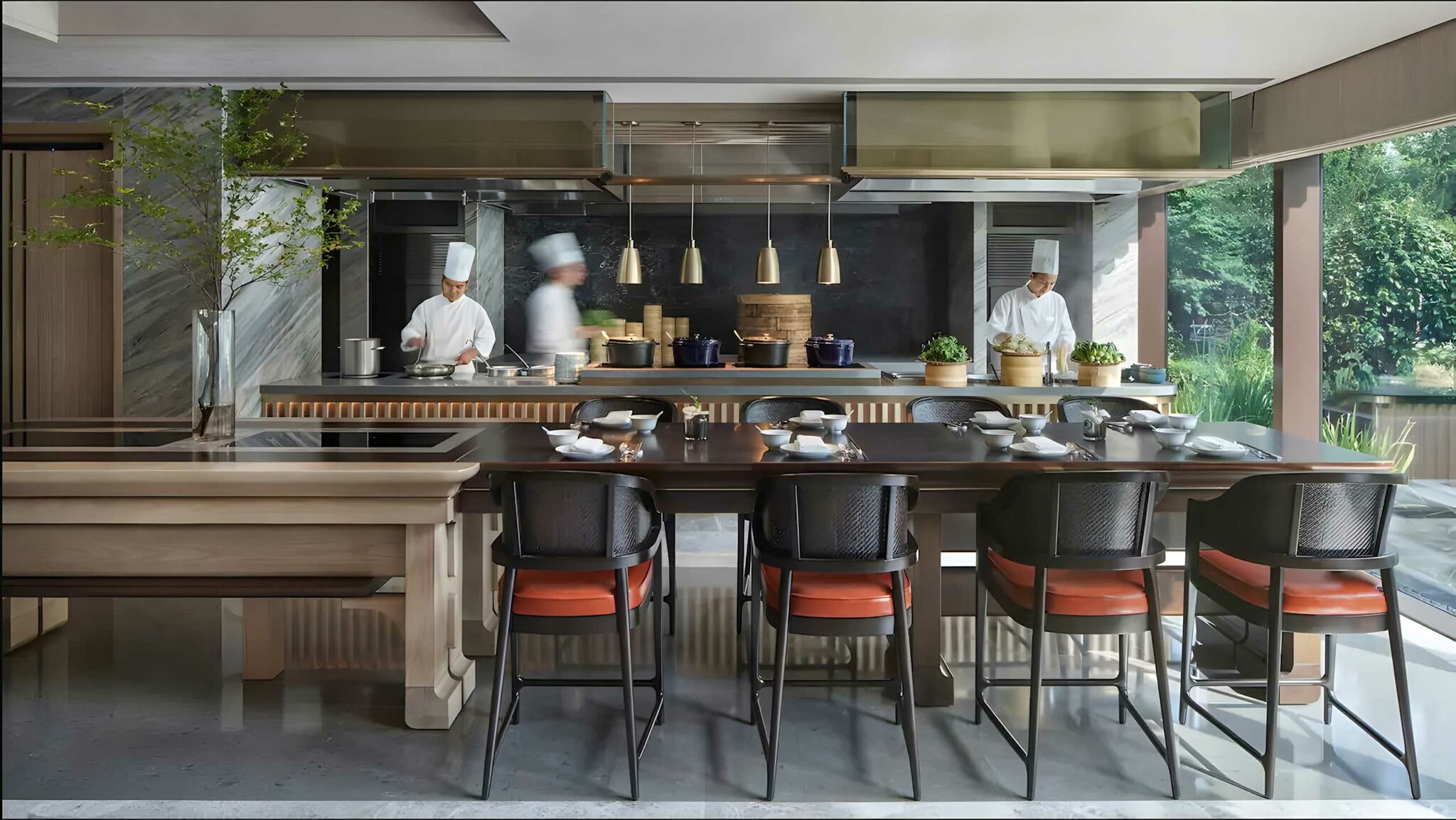 Park Hyatt Suzhou open kitchen dining area with chefs preparing dishes, marble finishes, crafted timber tables, and modern Jiangnan-inspired design