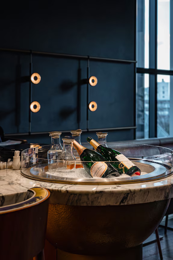 Champagne bottles presented on ice at District, Kimpton Shinjuku Tokyo, reflecting the bar programme and brand positioning shaped through market research and concept development by Social F+B.