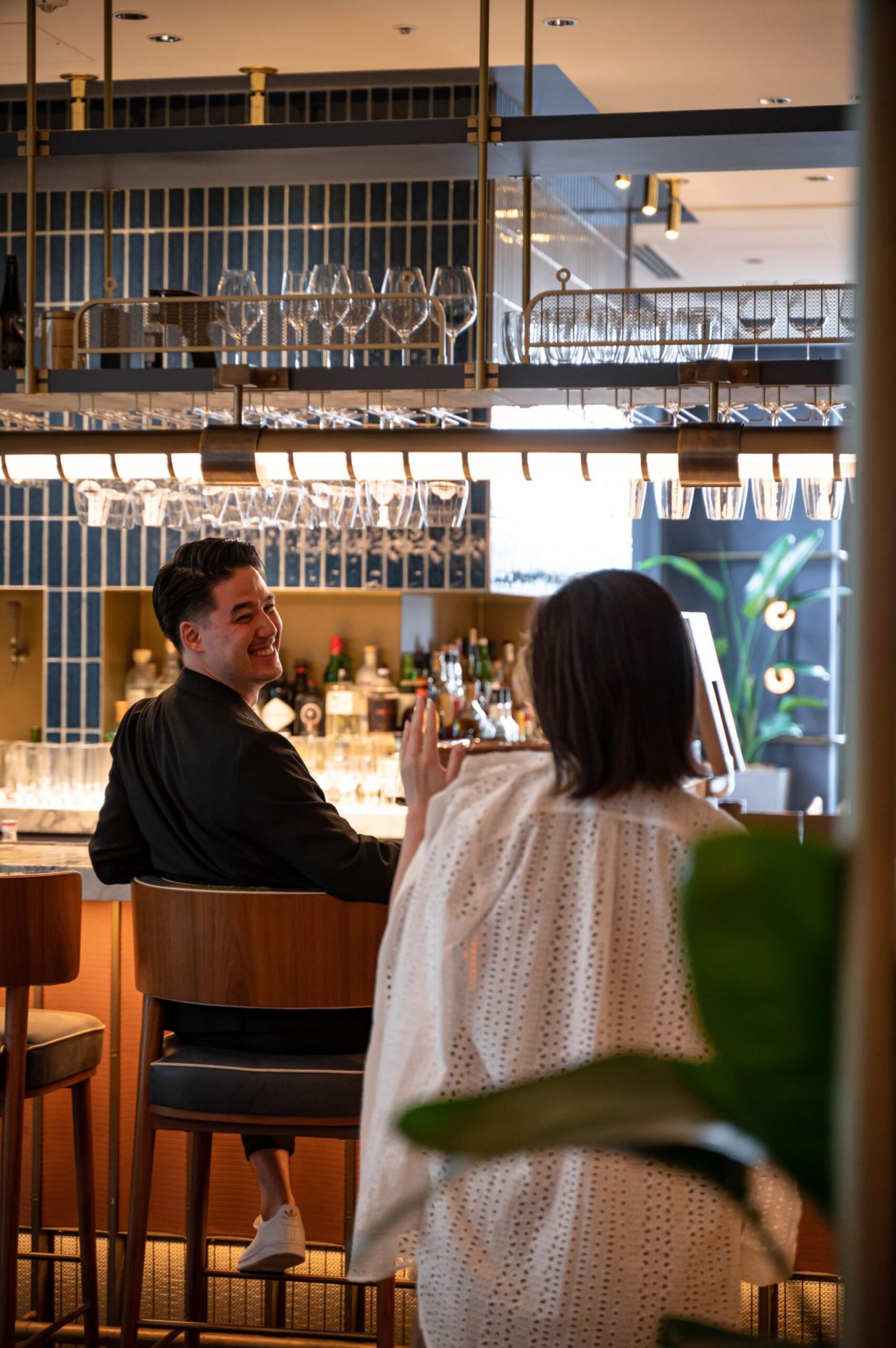 Guests interacting at the bar at District, Kimpton Shinjuku Tokyo, capturing the relaxed, social atmosphere shaped by the venue’s market-led concept and brand strategy.