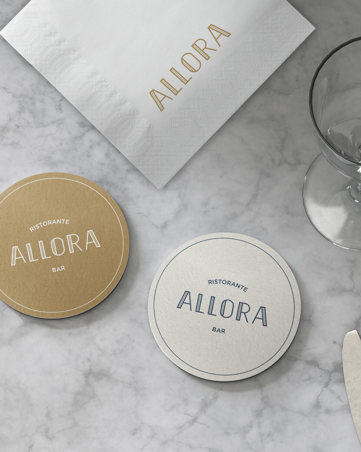 Allora Ristorante & Bar branded tableware featuring custom coasters, napkin, and menu collateral, highlighting a classic and timeless visual identity created by Social F+B and HBA Graphics for Crowne Plaza Changi Airport.