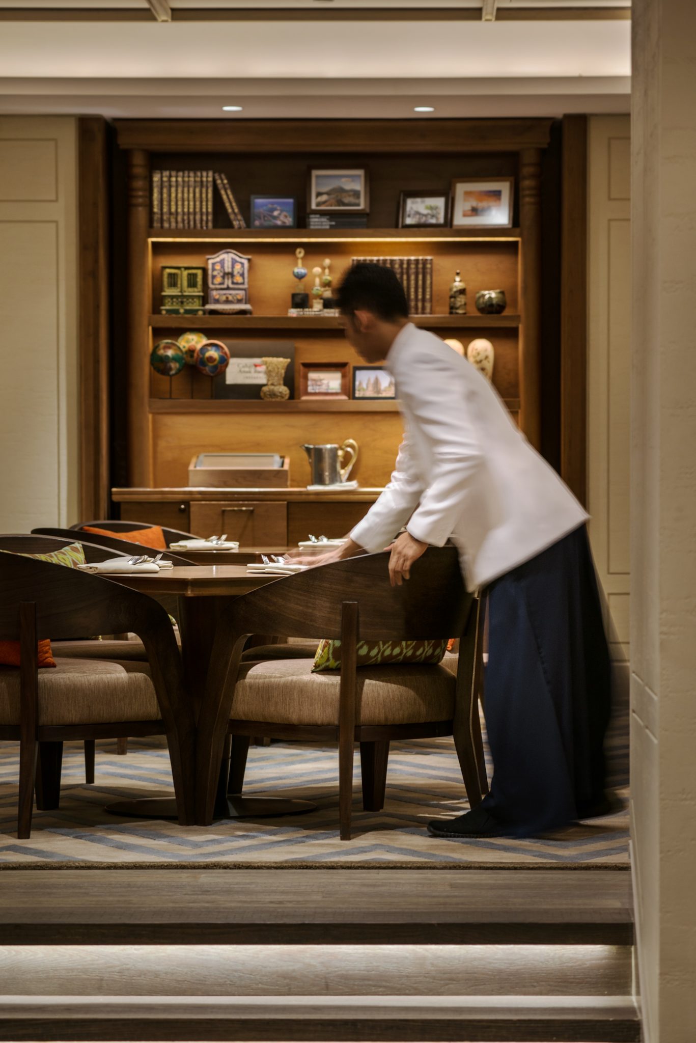Service staff preparing a table at Grand Café, Grand Hyatt Jakarta, capturing the attentive hospitality and relaxed all-day dining atmosphere of the venue.